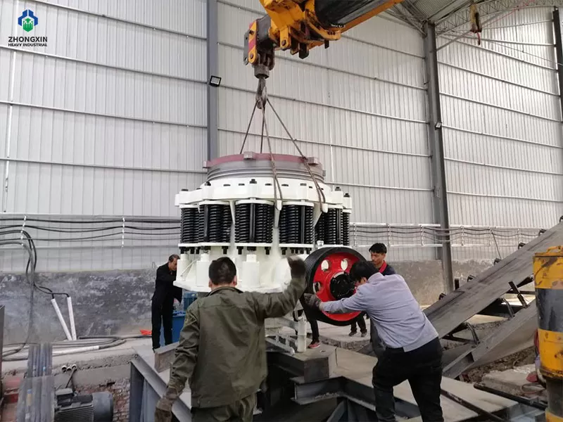 Secondary cone crusher crushing hard rock at quarry production site