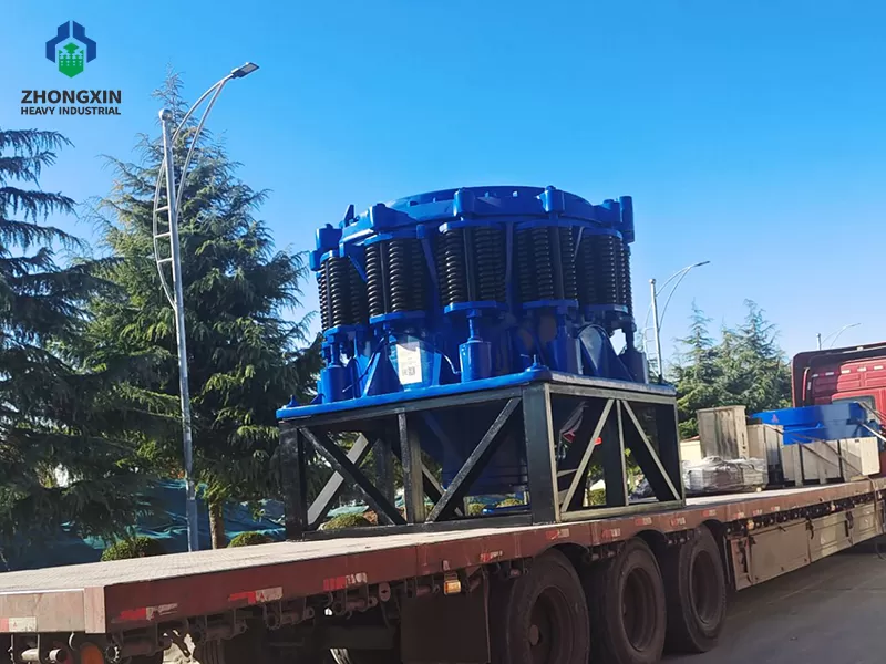 Cone crusher machine loaded on trailer for delivery to quarry project site