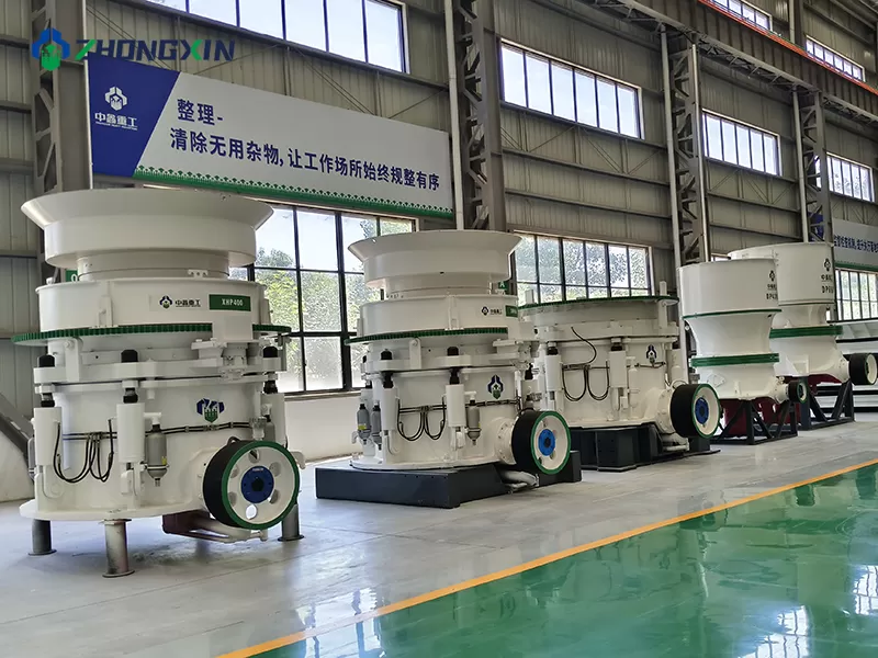 Zhongxin Heavy Industry workshop view showing an inventory of heavy-duty mining machinery, including multi-cylinder hydraulic cone crushers and single-cylinder cone crushers ready for delivery to quarry plant projects.