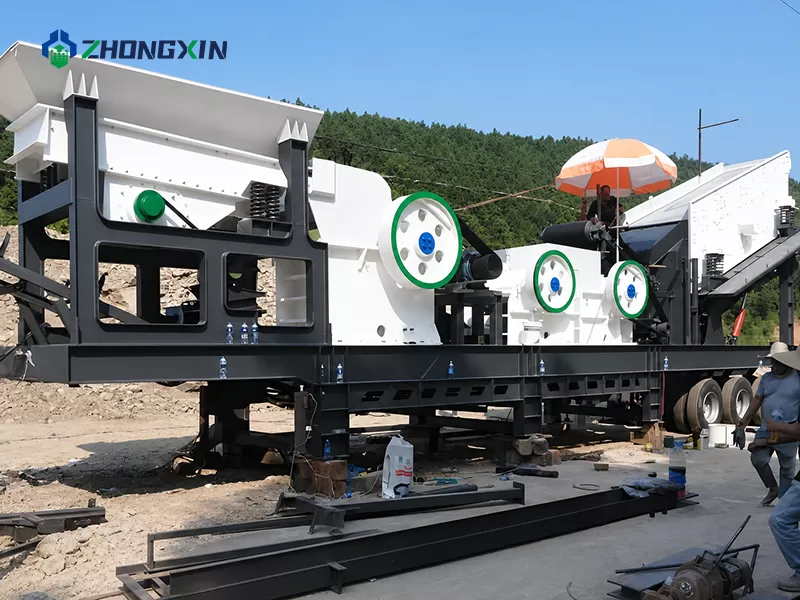 Mobile jaw crusher performing primary coarse reduction of large boulders in a remote mining project
