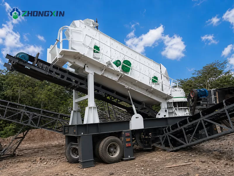 Multi-deck vibrating screen sorting crushed stones into various sizes on a mobile screening plant
