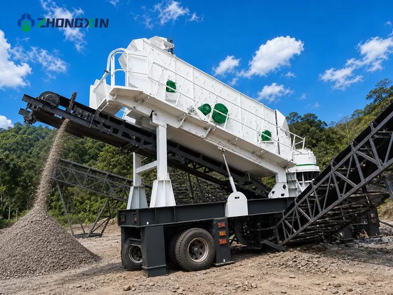 Tire-type mobile stone crusher operating with dust-suppression water sprays in a limestone quarry