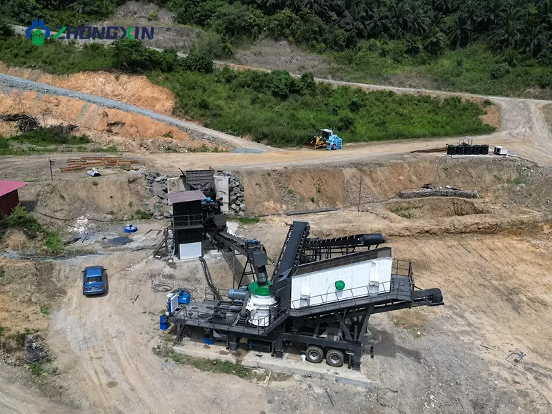 Aerial view of a mobile crushing station and stockpiles running at a short-term construction site