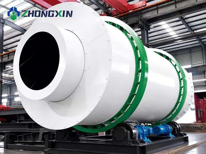 Dried material discharging from the outlet of the three-drum dryer