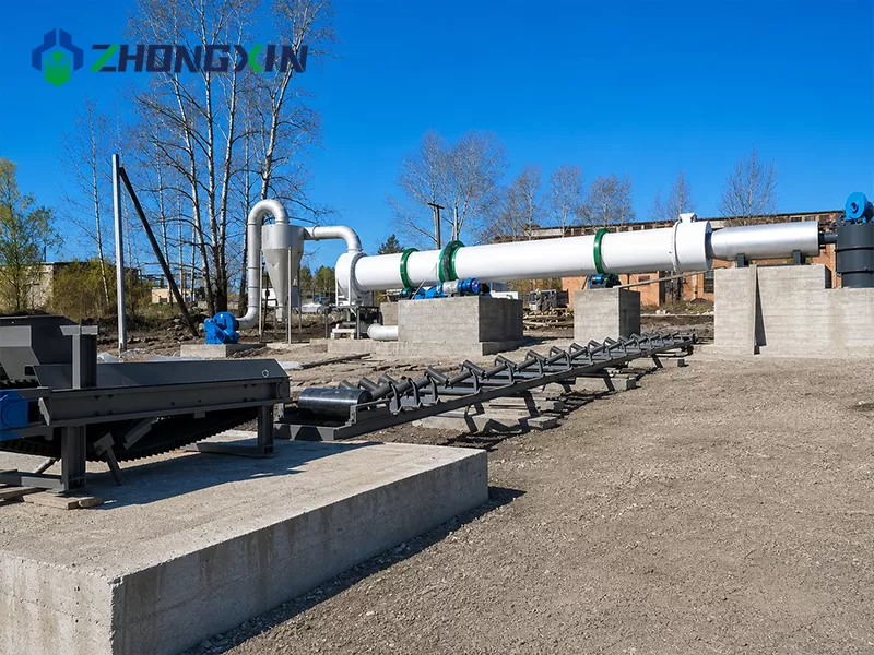 Outdoor storage yard with white rotary dryer shells and a truck under a clear sky