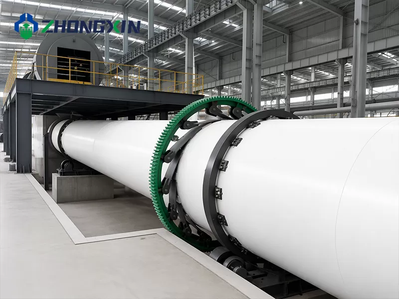 Side view of the single-drum dryer shell in a large workshop bay before assembly