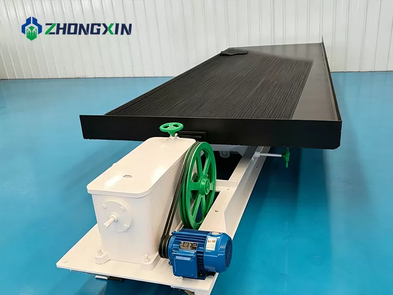 Shaking table front view in factory with rifled deck surface and feed box
