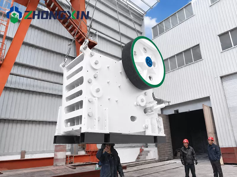 Loading European jaw crusher onto transport frame for international shipment.