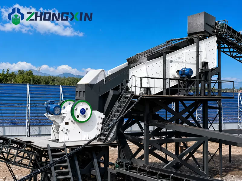 European jaw crusher operating in outdoor quarry stone crushing line.