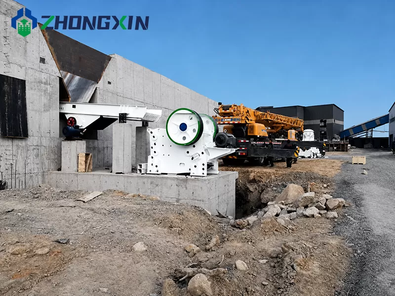 European jaw crusher operating in open-pit quarry stone crushing line.