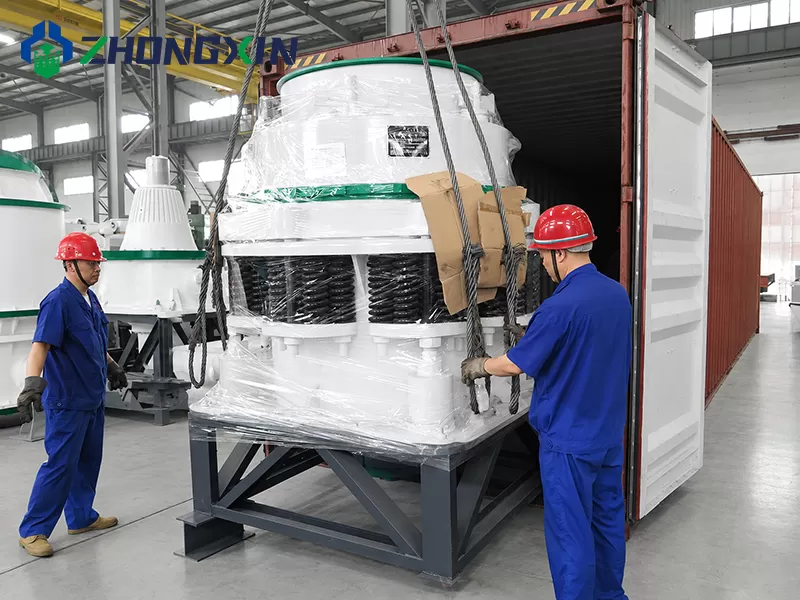 Engineers packing PSG Symons cone crusher into shipping container for export