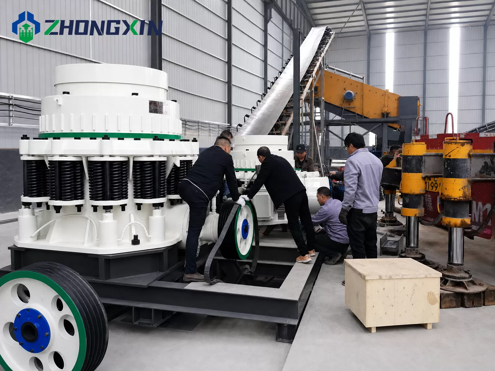 Crane lifting and installing ZX compound cone crusher at customer job site