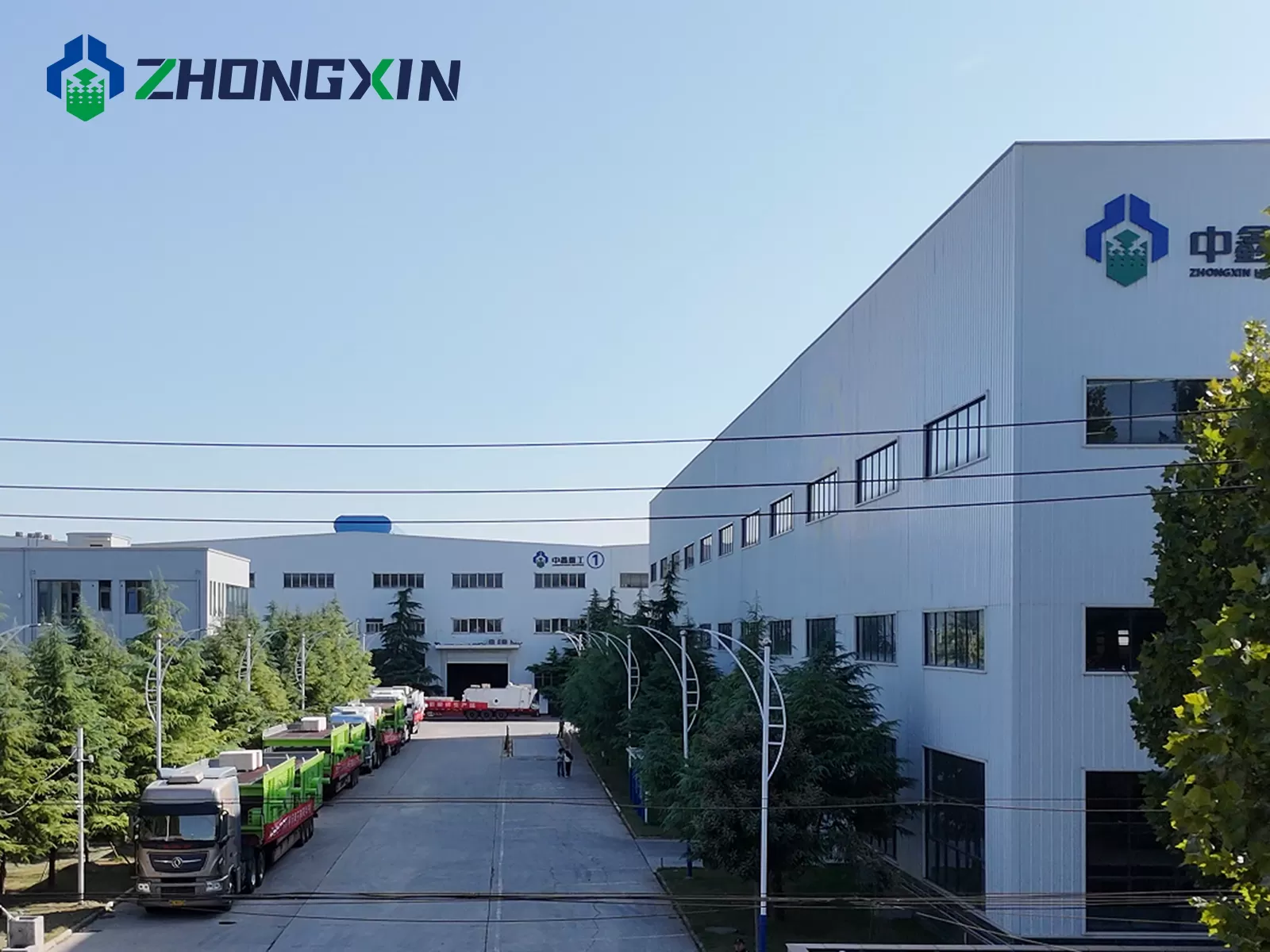 Complete logistics transport fleet lined up outside Jiaozuo Zhongxin headquarters building for Xinjiang proje.png