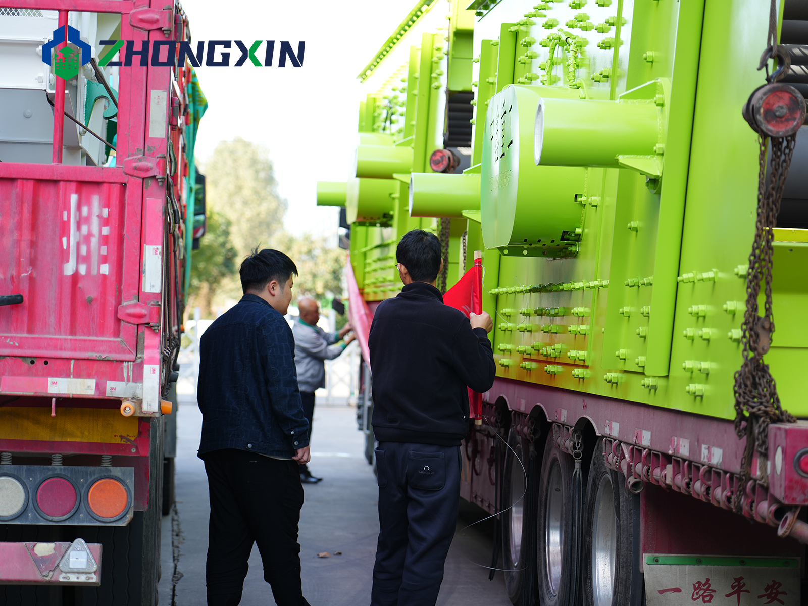 Jiaozuo Zhongxin quality control staff inspecting safety straps on vibrating screen transport vehicle.JPG